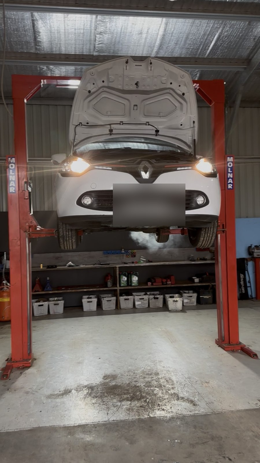 Renault Clio on the hoist with the bonnet up